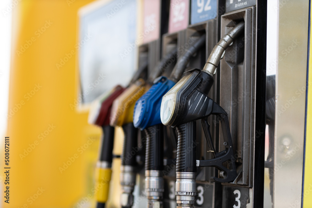 Close up filling gun in his hand at gas station. Sanctions economy crisis Close up filling gun in his hand at gas station. Sanctions economy crisis