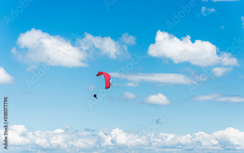 Fototapeta Naklejka Na Ścianę i Meble -  A tandem paraglider flight against a beautiful blue sky. Top view of the embers in the Beskid Mały. A popular place in Silesia. Bielsko Biała, Poland