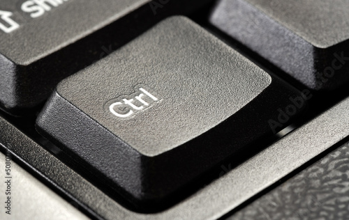 One single control key ctrl button on a simple desktop PC black office keyboard, object macro, extreme closeup detail, nobody. Taking control controlling, confidence symbol abstract concept, no people photo