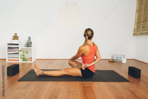 Mid-age woman practicing yoga in a yoga studio