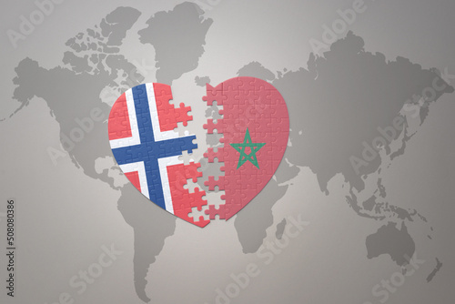 puzzle heart with the national flag of norway and morocco on a world map background. Concept.