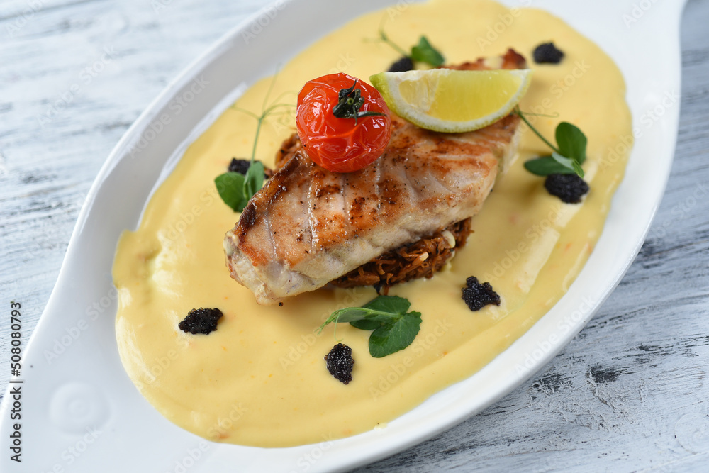 grilled fish fillet with vegetable puree, tomatoes and lemon grilled fish fillet with vegetable puree, tomatoes and lemon