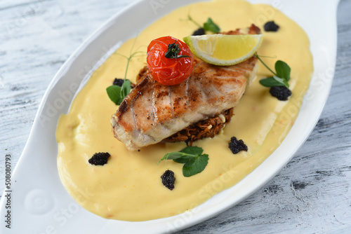 grilled fish fillet with vegetable puree, tomatoes and lemon