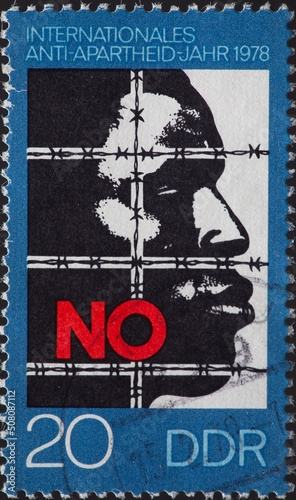 GERMANY, DDR - CIRCA 1978: a postage stamp from GERMANY, DDR, showing an African behind barbed wire. The word NO. Text: International Anti Apartheid Year 1978. Circa 1978