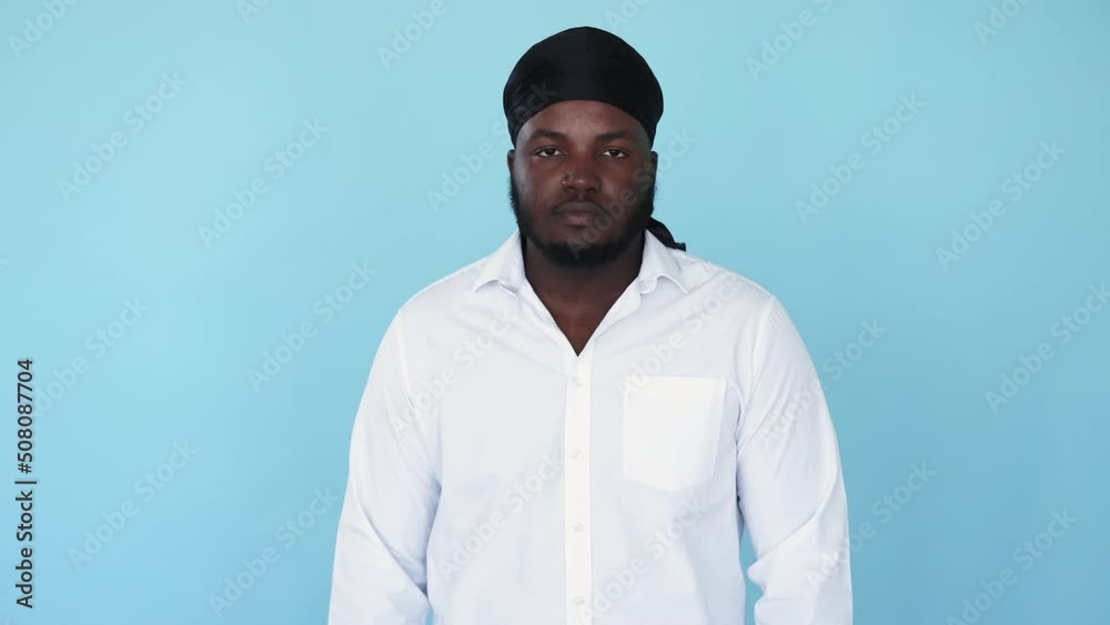 Hi gesture. Peace sign. Victory symbol. Boomerang motion. Serious greeting black man showing two fingers symbol isolated on blue background GIF loop animation. Hi gesture. Peace sign. Victory symbol. Boomerang motion. Serious greeting black man showing two fingers symbol isolated on blue background GIF loop animation.