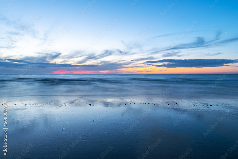 Fototapeta premium Colorful long exposure summer sunset along Oostende (Ostend) North Sea beach, Belgium.