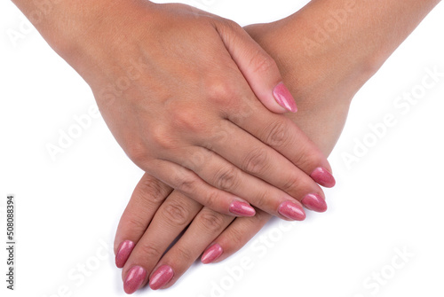 closeup of hands of a young woman with long pink manicure on nails isolated on white background