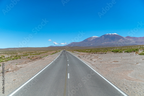 road in the mountains between the cliffs overlooking the snowy hills