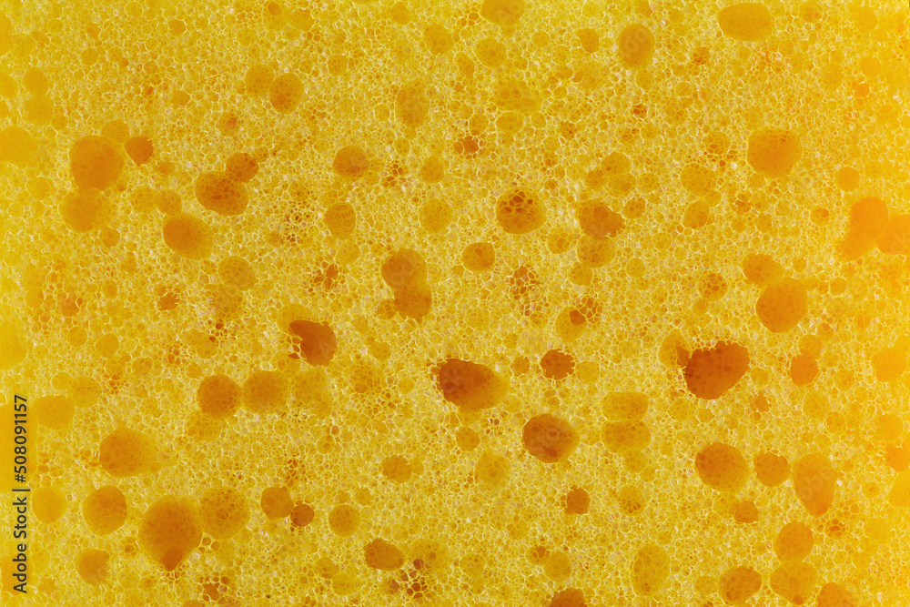 Dishwashing sponge texture close up photo. Yellow sponge pattern macro photography. - obrazy, fototapety, plakaty 