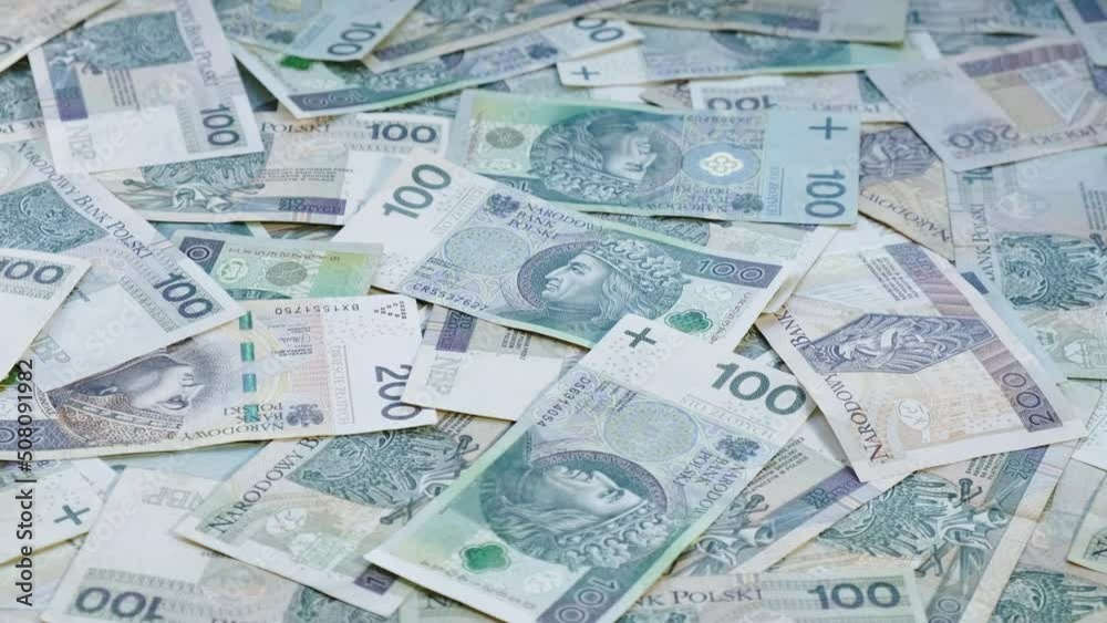 Polish currency - PLN - Pile of cash laying on the table while camera slowly orbits around - Front side of banknotes Polish currency - PLN - Pile of cash laying on the table while camera slowly orbits around - Front side of banknotes