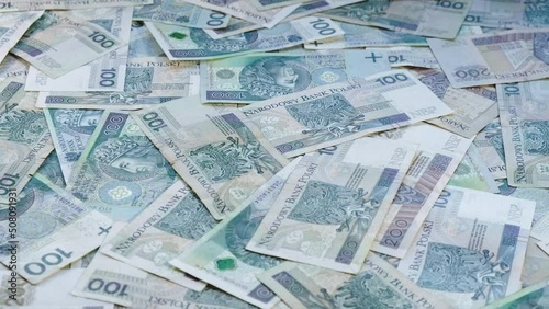 Pile of cash laying on the table while camera slowly orbits around - Back side of banknotes - Polish currency - PLN