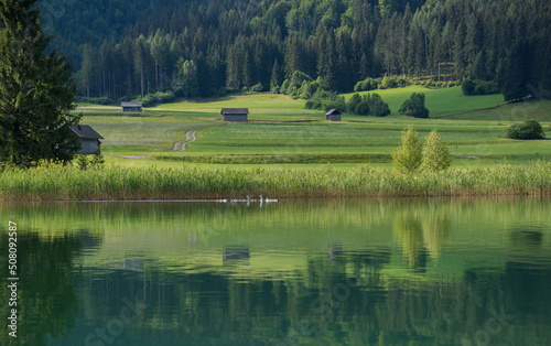 Weissensee lake in an early morning and a village