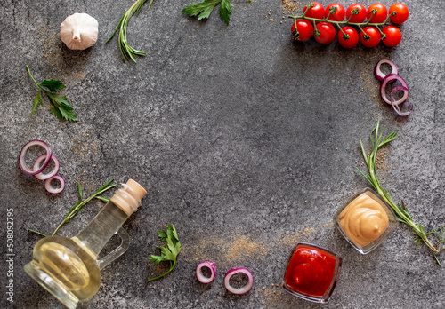 Gray stone background for cooking. Spices and vegetables. View from above. Free space for your text