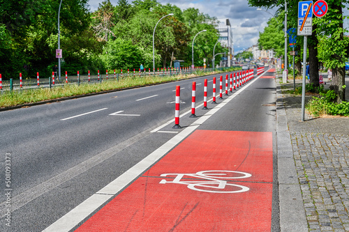 Separated bike lane on a main street in Berlin to improve road safety at the expense of parking lane.