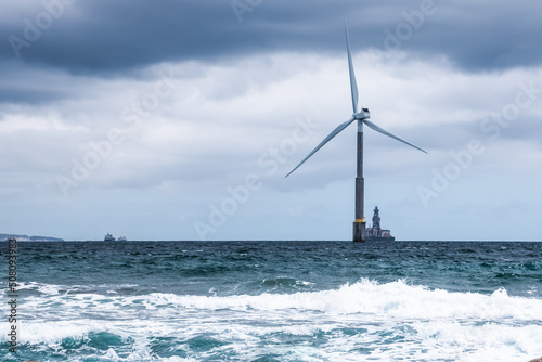 Offshore wind power. Wind turbine in the Telde sea, town of Gran Canaria island in a stormy day