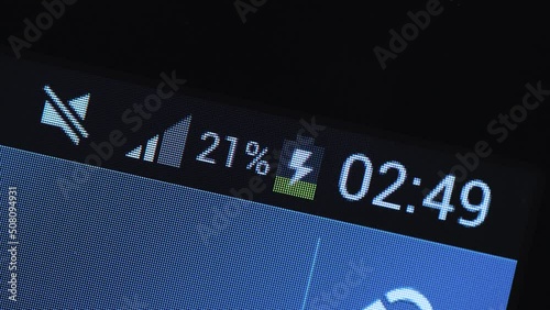 Smartphone fast battery charging indicator, low battery level, rechargeable battery electronic device charger connected simple concept, display macro, extreme closeup, nobody. Phone charging timelapse