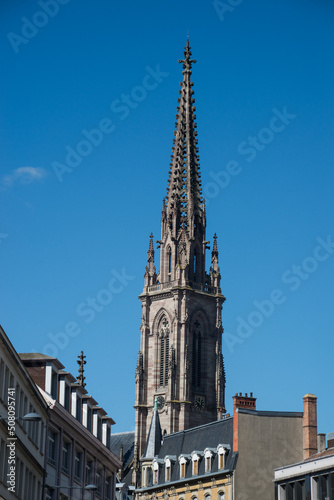 closeup of tower bell of the St Etienne protestant temple on blue cloudy sky background in Mulhouse - France