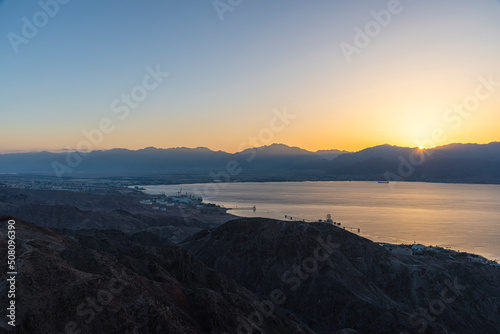 Dawn rises beyond the Aqaba mountains. Sunrise over the Red Sea. A look at Mount Shlomo, Eilat, Israel. High quality photo