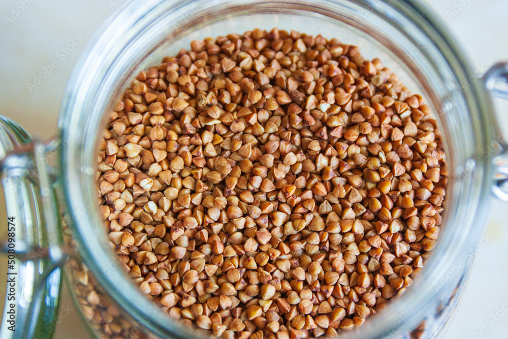Buckwheat in a jar, gluten free antique grain for a healthy diet, selective focus Buckwheat in a jar, gluten free antique grain for a healthy diet, selective focus