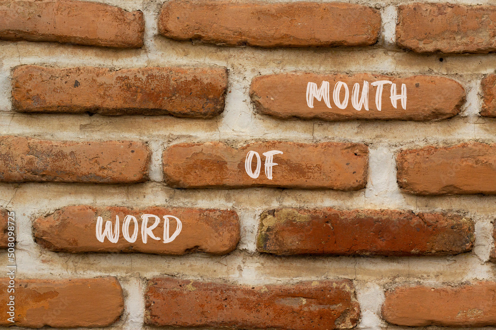 Word of mouth symbol. Concept words Word of mouth on red bricks on a beautiful brick wall background. Business, finacial and word of mouth concept. Copy space. Word of mouth symbol. Concept words Word of mouth on red bricks on a beautiful brick wall background. Business, finacial and word of mouth concept. Copy space.