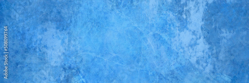 Elegant blue background with vintage grunge texture. Old blue paper. Light and dark blue website header or banner color. Distressed rusted textured metal background design with no people.