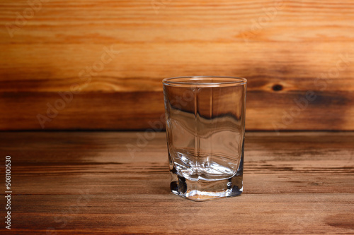 Empty glass stack on a wooden background, close-up
