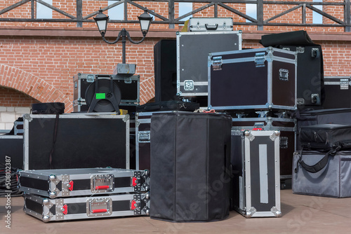 a lot of black boxes and reinforced suitcases with expensive equipment