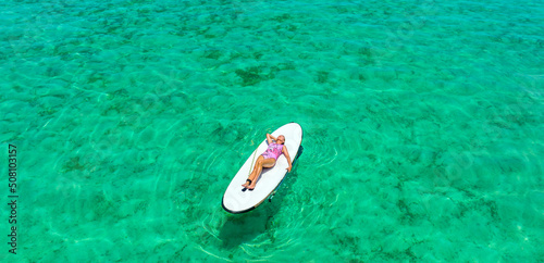 Holidays in the Maldives. Paradise tropical beach. Woman on the background of the sea and sunny beach. Travel, tourism and relaxation