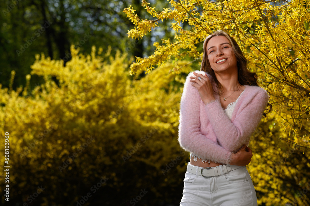 Beautiful young woman near blossoming shrub on spring day, space for text Beautiful young woman near blossoming shrub on spring day, space for text