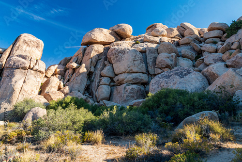 peculiar rock formations of big boulders of rock in Joshua Tree national Park in California on a clear ,blue summer's day.