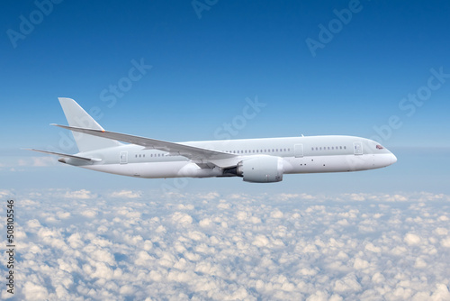 Commercial airplane jetliner flying above cumulus clouds in beautiful light. Travel concept.