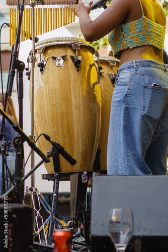 Fototapete Unidentified black woman playing percussion at outdoor concert