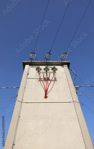 bare copper cables and insulated red electrical wires in the big substation photo