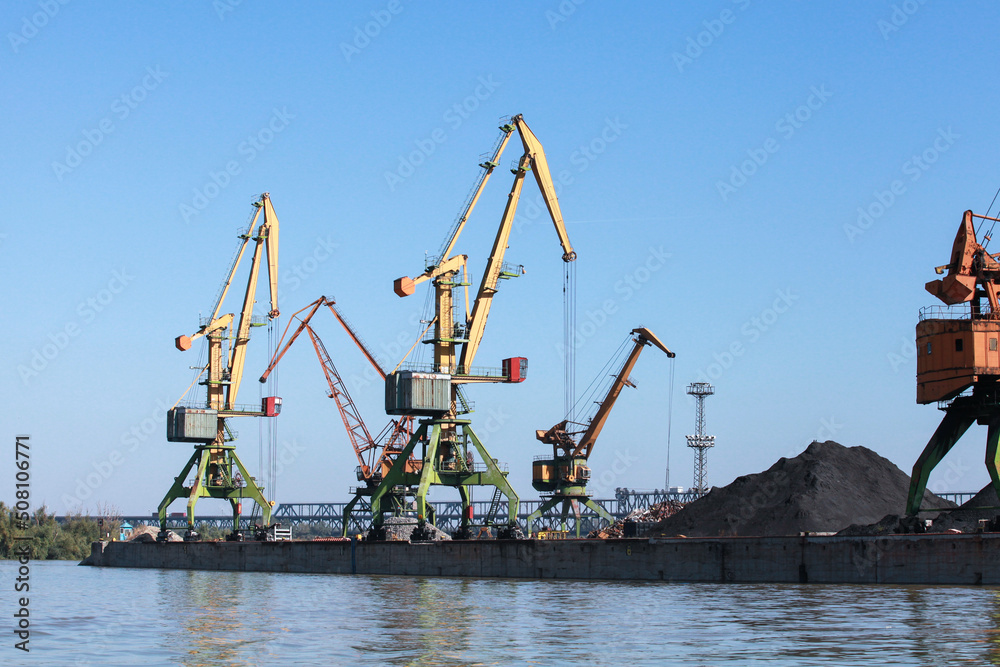 Port cranes stand on a quay in harbor, Black Sea coast