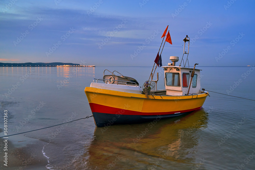 Picturesque moored fishing boat on beach in Sopot, Pomorskie region, Poland