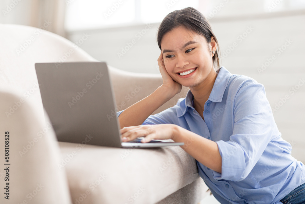 Closeup of smiling asian lady typing on notebook keyboard Closeup of smiling asian lady typing on notebook keyboard