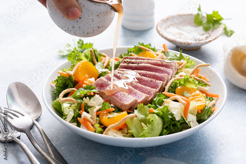 Seared tuna with asian crunchy salad with oranges photo