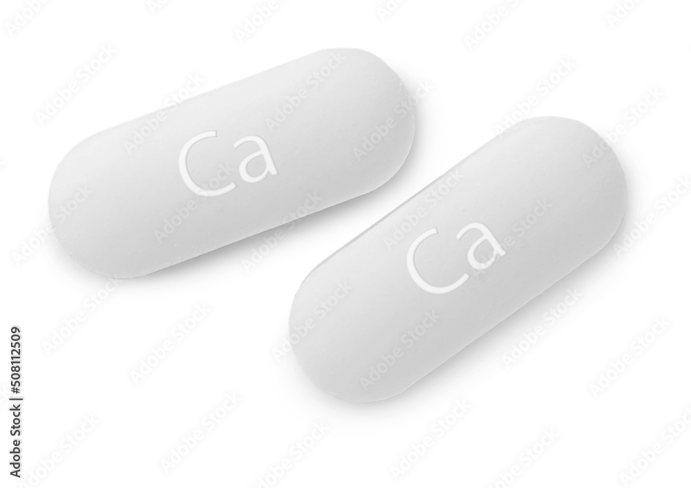 Two calcium supplement pills on white background, flat lay Two calcium supplement pills on white background, flat lay
