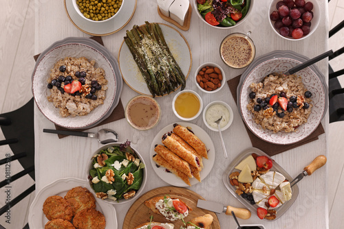 Many different dishes served on buffet table for brunch, flat lay