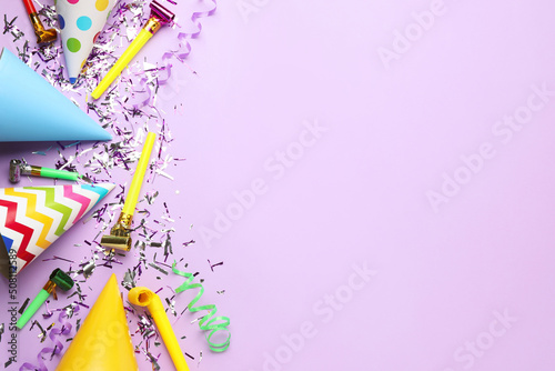 Beautiful flat lay composition with festive items on violet background, space for text. Surprise party concept