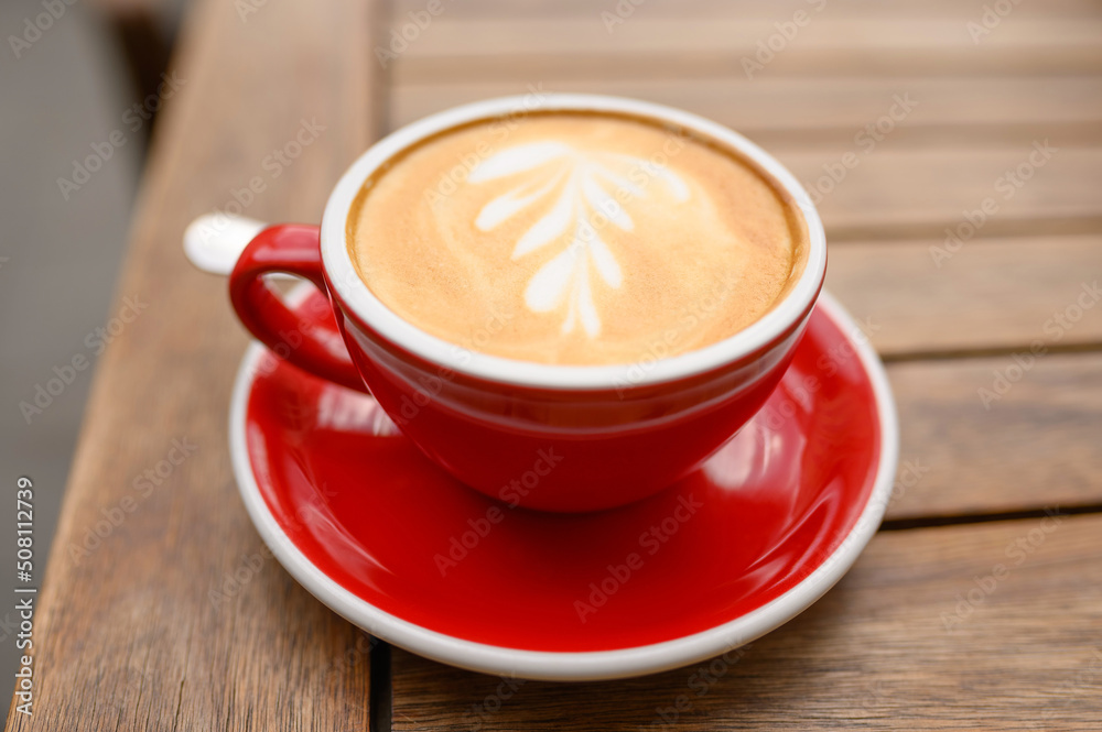 Cup of aromatic coffee on wooden table, closeup