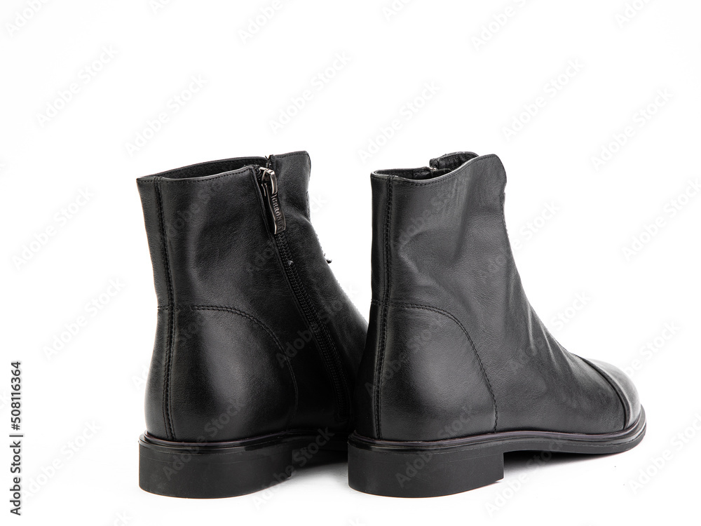 Women's autumn black leather jodhpur boots with zip and average heels, isolated white background. Back side view. Fashion shoes.