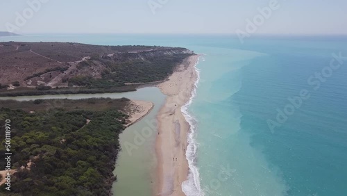 Aerial drone view of the Natural Reserve Foce del Fiume Platani and Capo Bianco in Sicily with turquoise sea and white limestone cliffs on a sunny summer day. Province of Agrigento near Eraclea Minoa. photo