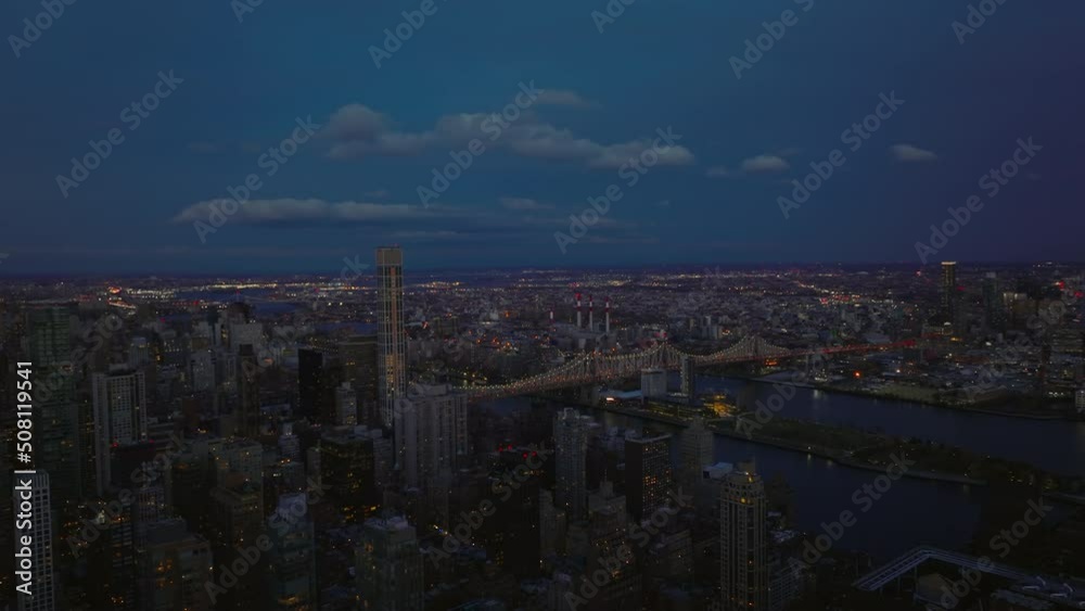 Aerial panoramic view of busy Queensboro Bridge over East River. Clouds in sky over evening city. Manhattan, New York City, USA Aerial panoramic view of busy Queensboro Bridge over East River. Clouds in sky over evening city. Manhattan, New York City, USA