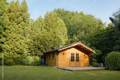 Small cottage in the countryside. Garden house made of wood. Cottage in your own garden for hobbies and free time during the pandemic. Shed in a large garden in Germany