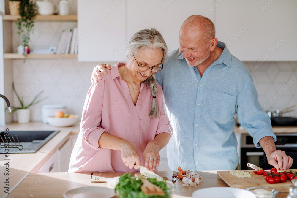 Happy senior couple cooking together at home. Happy senior couple cooking together at home.