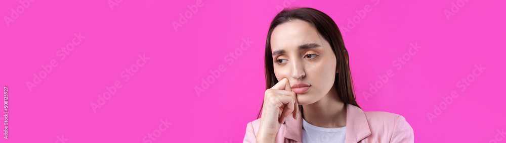 Portrait of beautiful young woman in pink jacket thinking isolated on red background Portrait of beautiful young woman in pink jacket thinking isolated on red background