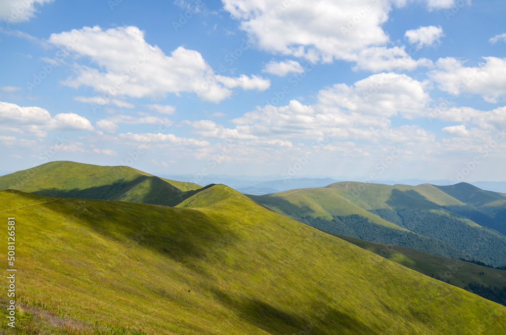 Picturesque landscape with mountain range, green slopes and alpine meadow at summer day. Carpathian Mountains, Ukraine Picturesque landscape with mountain range, green slopes and alpine meadow at summer day. Carpathian Mountains, Ukraine