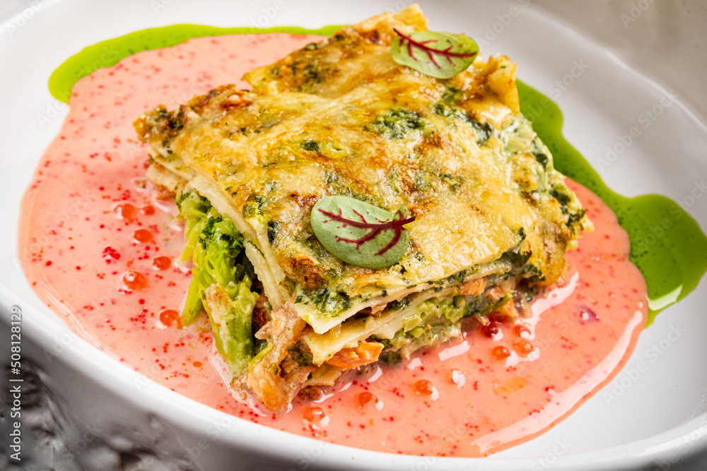A piece of lasagna on a white plate A piece of lasagna on a white plate