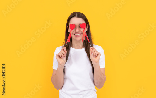 smiling girl with love symbol on yellow background. love romantic gift. sweetheart.